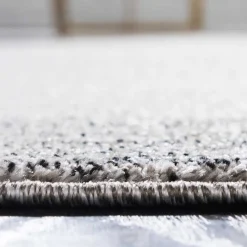 Teppich in Hellgrau mit dunkelgrauem Rand - Armina