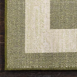 Teppich in Oliv Grün mit Rahmen in Creme - Loritana