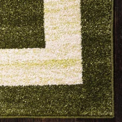 Teppich in Oliv Grün mit Rahmen in Creme - Loritana